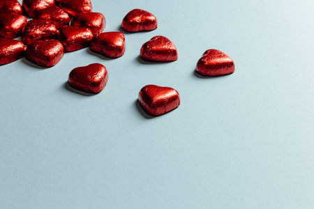 A saint valentine mock up with colorful red hearts over a pastel blue background for the love day...