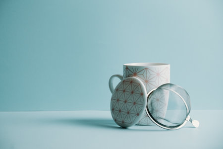 A clean cup of tea over a pastel blue background with copy spaceの写真素材