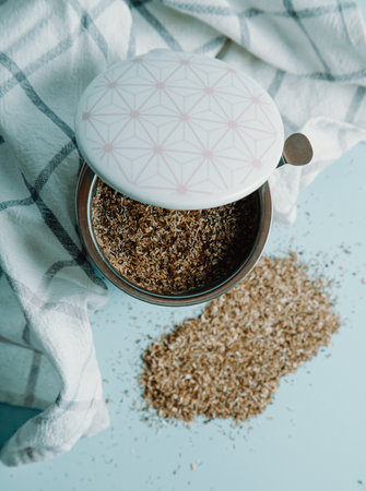 A cup of tea over a pastel blue background with tea aroundの写真素材