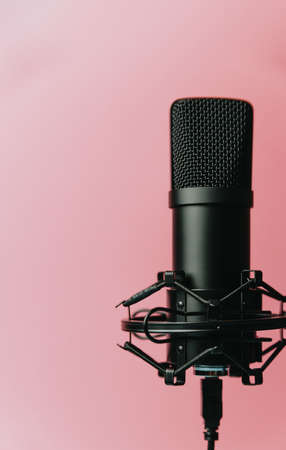 Minimalistic image of a streaming microphone over an pastel pink background with copy space, minimal concept, technology streamingの写真素材