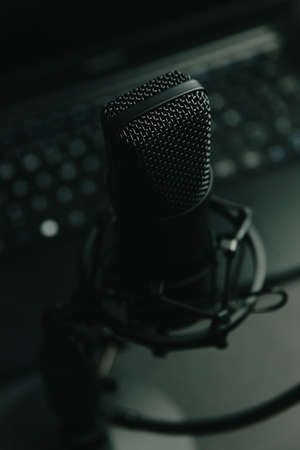 Close up mock up of a streaming microphone with a laptop with copy space, technology streaming, space work at homeの写真素材