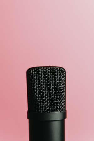 Minimalistic image of a streaming microphone over an pastel pink background with copy space, minimal concept, technology streamingの写真素材