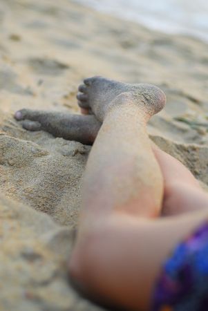 Legs of young woman on the beachの写真素材
