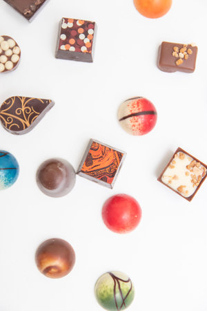 lot of variety chocolate pralines, top view of various chocolate pralines isolated on white...