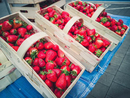 Many fresh strawberries in boxes for sale at a fruit market outdoors. Top view. Healthy foodの写真素材