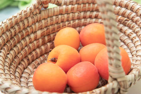 ripe apricots in plate on the table. Orange apricots fruits in bowl. Juicy apricots nutritionの写真素材