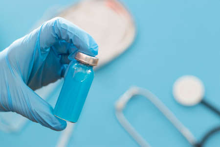 Vaccine vial and injection Needle Syringe against infection in hand of doctor. Medical, health, Vaccination and immunization conceptの写真素材