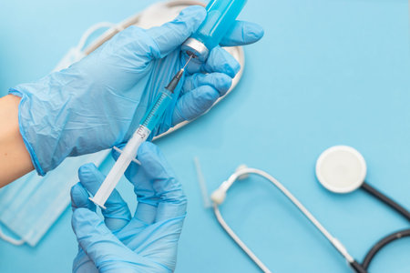 Vaccine vial and injection Needle Syringe against infection in hand of doctor. Medical, health, Vaccination and immunization conceptの写真素材