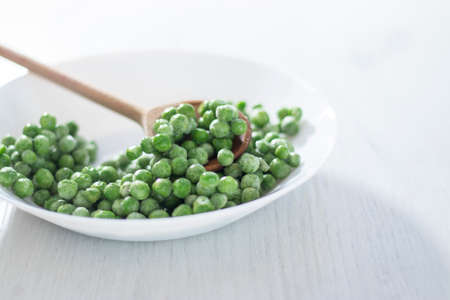 green peas in a white plate on a white background,の写真素材