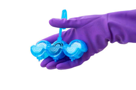 Person in purple protective rubber gloves holds multi-colored balls of toilet bowl cleaner. isolated on white background isolation. Selective focus, close-up,の写真素材