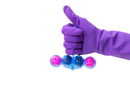 Person in purple protective rubber gloves holds multi-colored balls of toilet bowl cleaner. isolated on white background isolation. Selective focus, close-up,の写真素材
