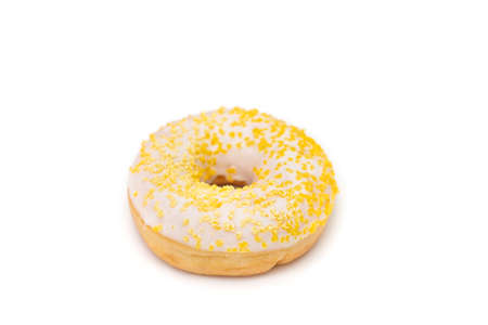 Donut with white sugar glazed and sprinkled with yellow pastry crumbs, on a isolated background with copy space,の写真素材