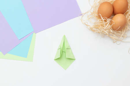DIY Children's Easter craft bunny with an egg. Step 9. Easter paper step by step instructions. Happy bunny holds egg. Children's Art Project, needlework, crafts for children, springtimeの写真素材