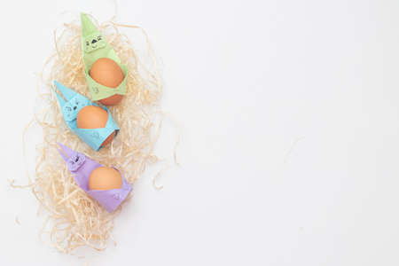 Happy bunny holds egg. DIY Children's Easter craft bunny with an egg. postcard for easter holiday.の写真素材