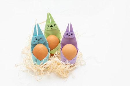 Happy bunny holds egg. DIY Children's Easter craft bunny with an egg. postcard for easter holiday.