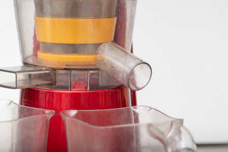 Woman making fresh drink. Juice and apple juice. Fruits in background. Clean eating, detox conceptの写真素材