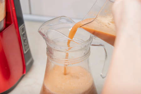 Woman making fresh drink. Juice and apple juice. Fruits in background. Clean eating, detox conceptの写真素材