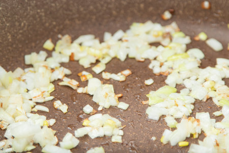 Close up view of the fried onion on a frying pan. Selected Focusの写真素材