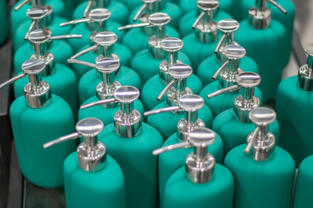 Many bottles with dispenser for a wide range of cosmetic products such as: liquid soap, cream, hair conditioner, shower gel, antiseptic on sale. Close up view.の写真素材