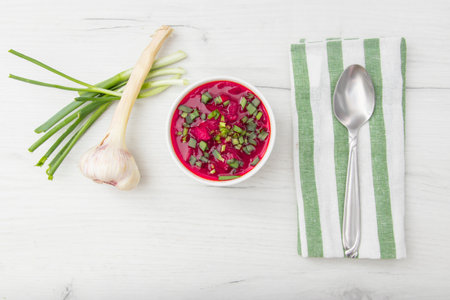 Borscht traditional beetroot soup, Ukrainian and Russian national cuisine. served in white bowl on wooden board. Top view, flat layの写真素材
