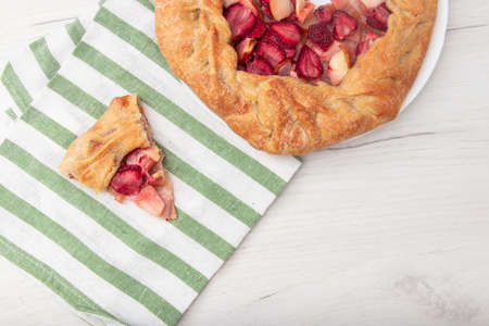 Apple strawberry pie, top view side border against a rustic wood background with copy space. Autumn food concept. Step by step recipe galetteの写真素材