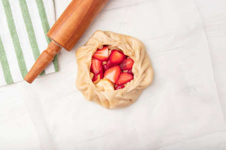 Apple strawberry pie, top view side border against a rustic wood background with copy space. Autumn food concept. Step by step recipe galette,の写真素材