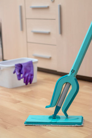 house cleaning - mop washing wooden floor. Wet cleaning concept background.