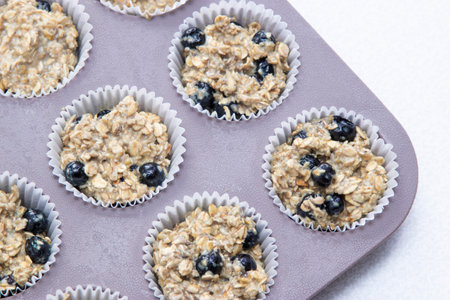 Homemade Breakfast Oatmeal Muffins in muffin tray. Super healthy delicious sugar free, oil free and flour free muffins made of ripe bananas. Vegetarian dessert. Top view foodの写真素材