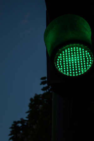 evening car traffic light night giving way to green lightの写真素材