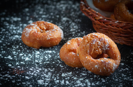 detail of some homemade donuts with glass sugar on a black background