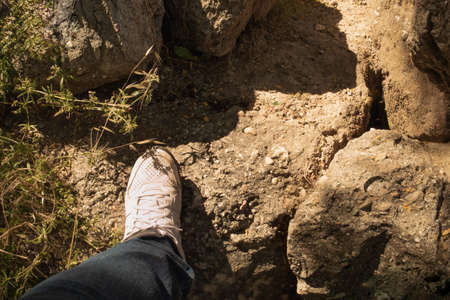 foot with a white shoe on top of the rock climbingの写真素材