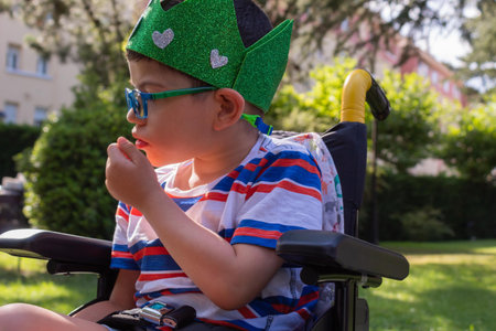 child in wheelchair with Pitthopkins syndrome celebrating his birthday with a handmade wreath