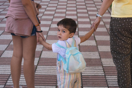 mother taking her children to school at the beginning of the school year
