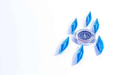 Group of blue paper ships with compass marking the north concept to steer a business on the right trackの写真素材