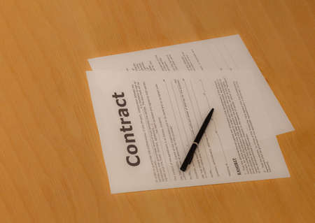 Contract ready to sign on the wooden tableの写真素材