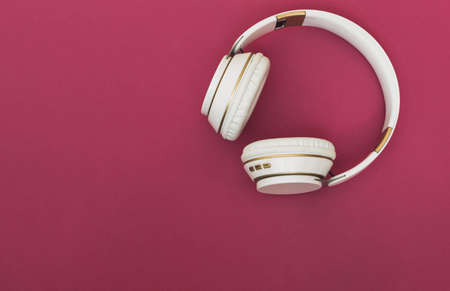 wireless headphones white on fuchsia background with music and relaxation concept copy spaceの写真素材