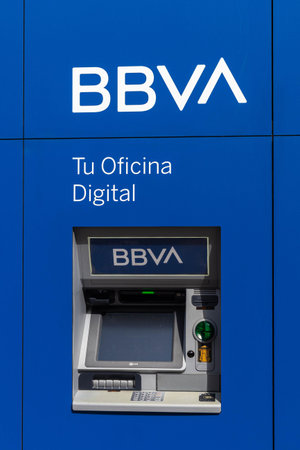 BBVA Bank ATM in the city on a corporate blue background
