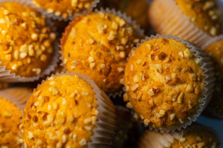 selective selection of delicious homemade muffins with almond pieces fresh from the oven for a...