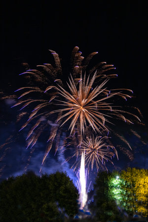 flash of fireworks of different colors in the middle of the night with selective focus concept to celebrate eventの写真素材