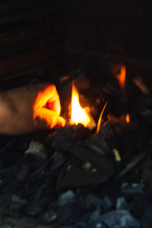 vertical photo of a fire pit and glowing embers for a barbecue with selective focus