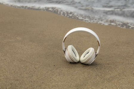 wireless helmets located on the shore of the beach with waves of the sea and copy space concept relaxationの写真素材