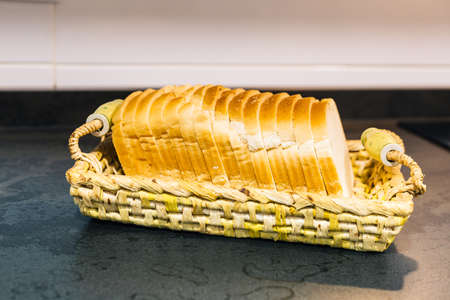 tray with slices of fresh square bread for toastの写真素材