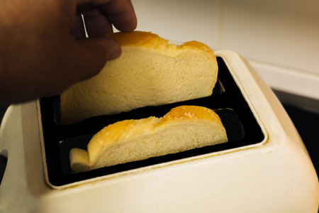 man taking toast out of the toast machine for breakfast
