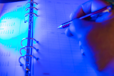 businessman making notes in his diary with blue selective focus