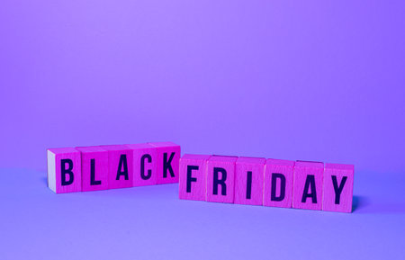 wooden letters with the word BLACK FRIDAY announcing purchase offer on a blue backgroundの写真素材