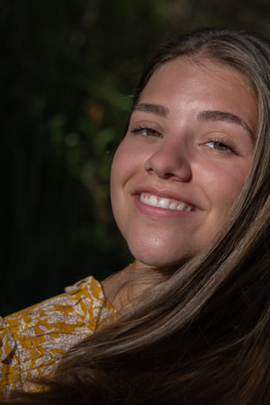 portrait attractive young girl with long hair with a smile showing white teeth concept oral hygieneの写真素材