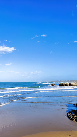 vertical landscape of a beach with rocks expressing tranquility and copy spaceの写真素材