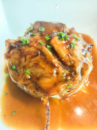 Main meat dish with brown sauce and chives served in modern gourmet cuisine