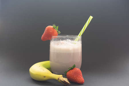 Strawberry and banana smoothie in a glass cup. Highly recommended drink for our health. It is a very healthy drink.の写真素材