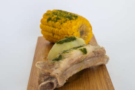 Potatoes, pineapples and ribs, a typical dish from the island of Tenerife. The potatoes, pineapples and ribs are accompanied by a green mojo. The green mojo is coriander. Tipical from canary islands.の写真素材